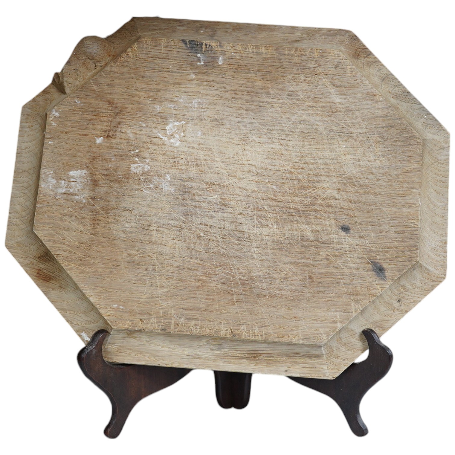 A Mouseman carved oak octagonal bread board, 30cm wide x 25cm deep. Condition - faded and scored